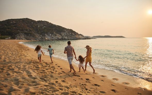 Family running along beach