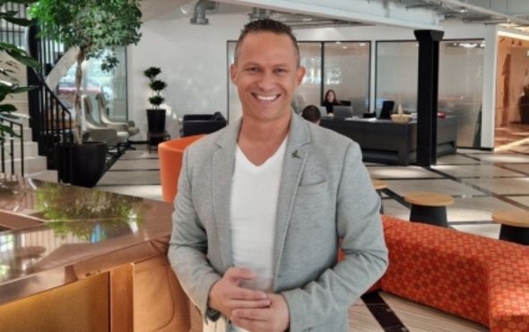 A man smiling in an office