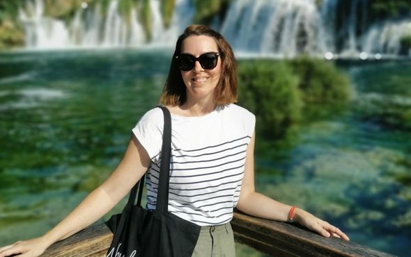 Woman in front of Croatia waterfall
