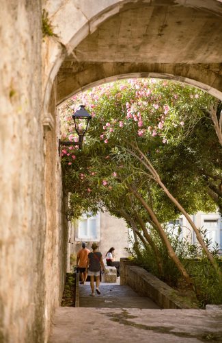 Korcula Old Town with man walking through an archway