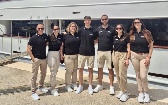 Seven members of the Unforgettable Croatia team standing outside the luxury ship My Wish in Croatia